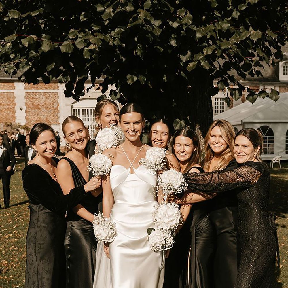 Black bridesmaid dresses with bride in satin white gown