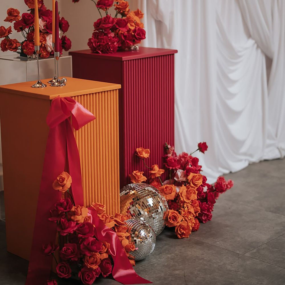 Orange and pink wedding decor pillars