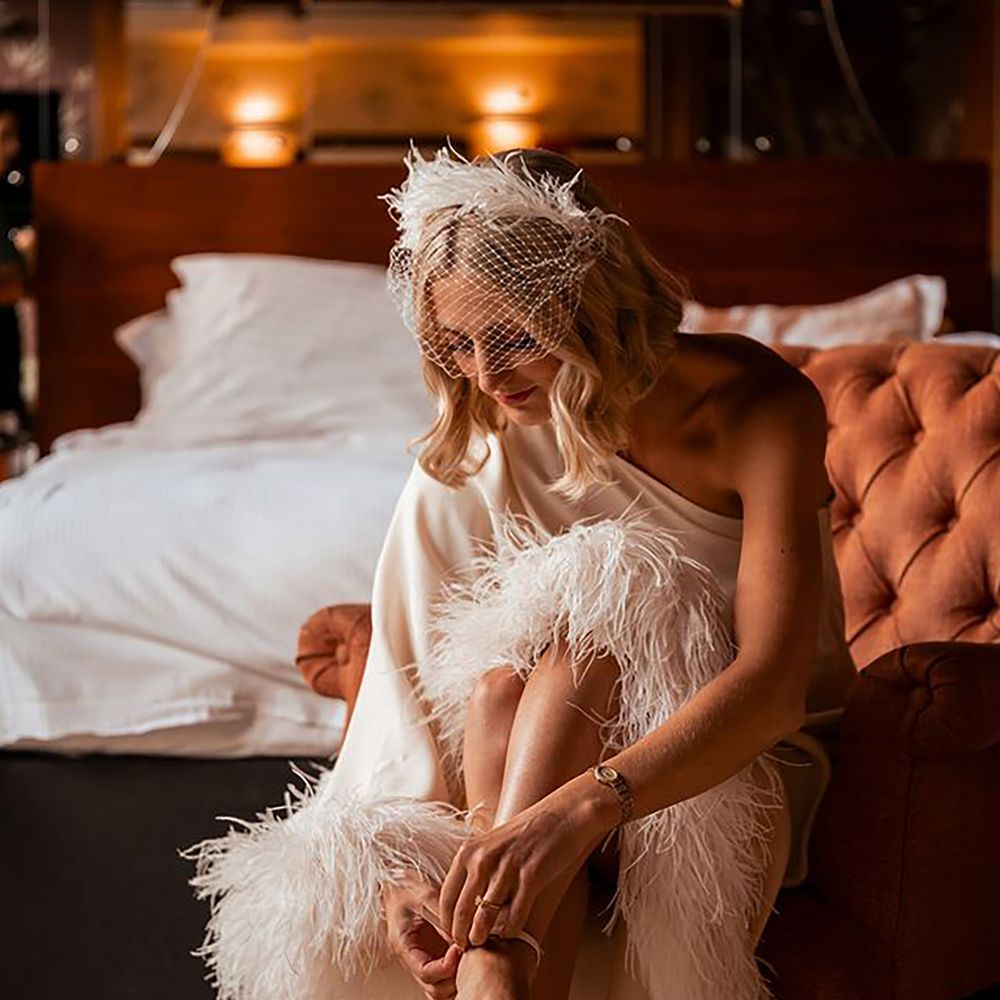 Showgirl style feather wedding dress for hen do themes