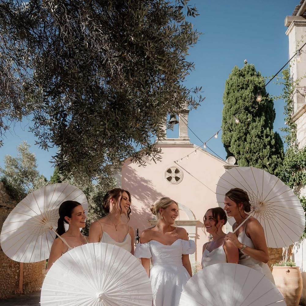 Cream summer bridesmaid dresses with umbrellas