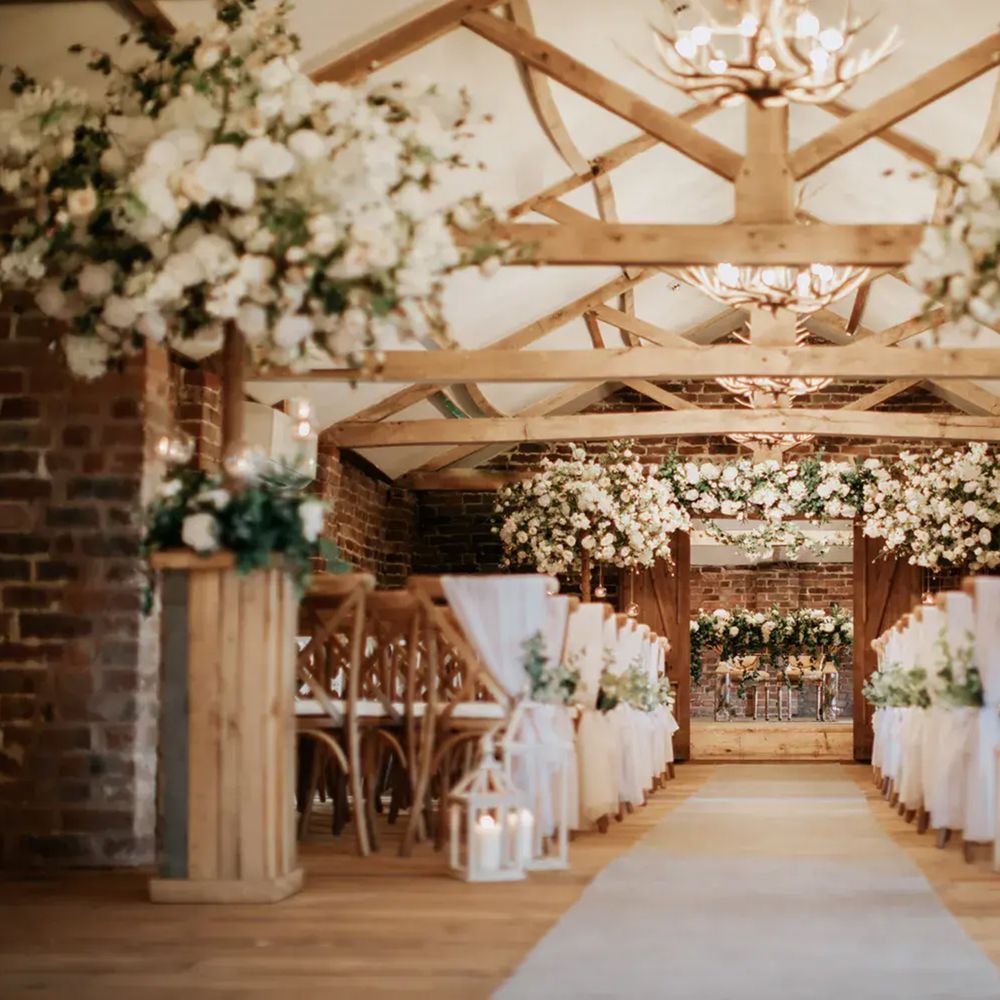 Burtlon Manor ceremony room grand high ceiling barn white floral decor