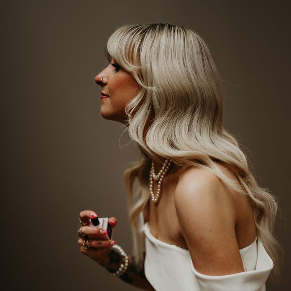 Bride Sprays Wedding Perfume with Long Blonde Hair