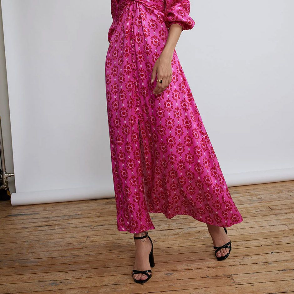 long sleeve pink cocktail wedding guest dress, featuring retro-inspired pink heart motif, wrap waist and volume sleeves