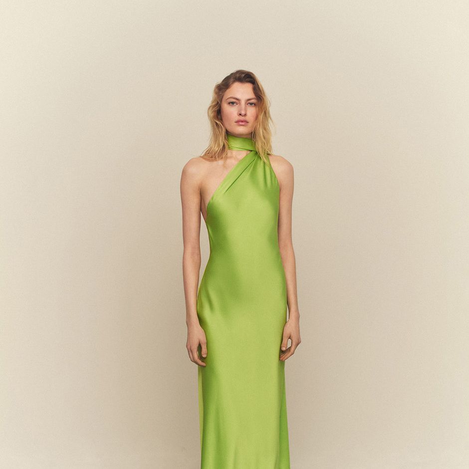 flowy green satin black tie wedding guest dress with asymmetric neckline