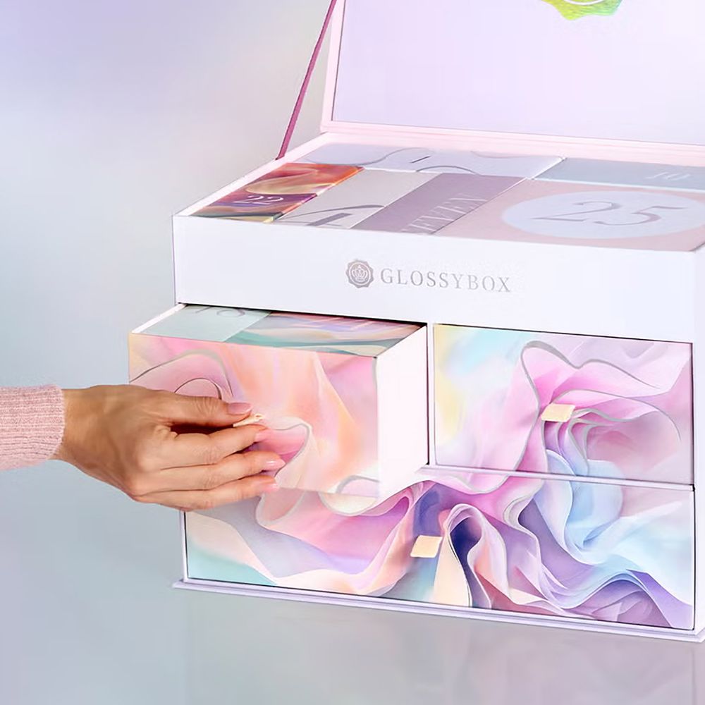 Glossybox beauty advent calendar 2025 image of someone opening drawers of the calendar