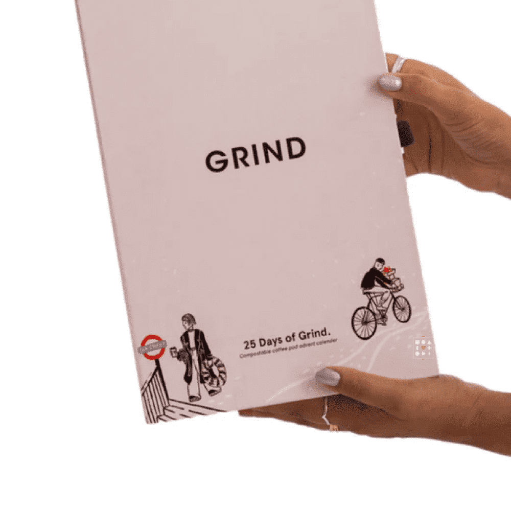 Person holding the 2025 Grind Coffee Advent Calendar