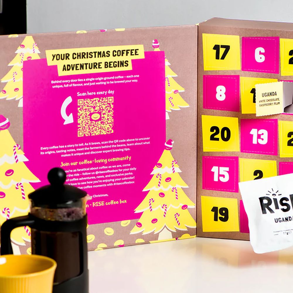Rise Coffee Advent Calendar 2025 lifestyle image of open calendar with someone holding granules