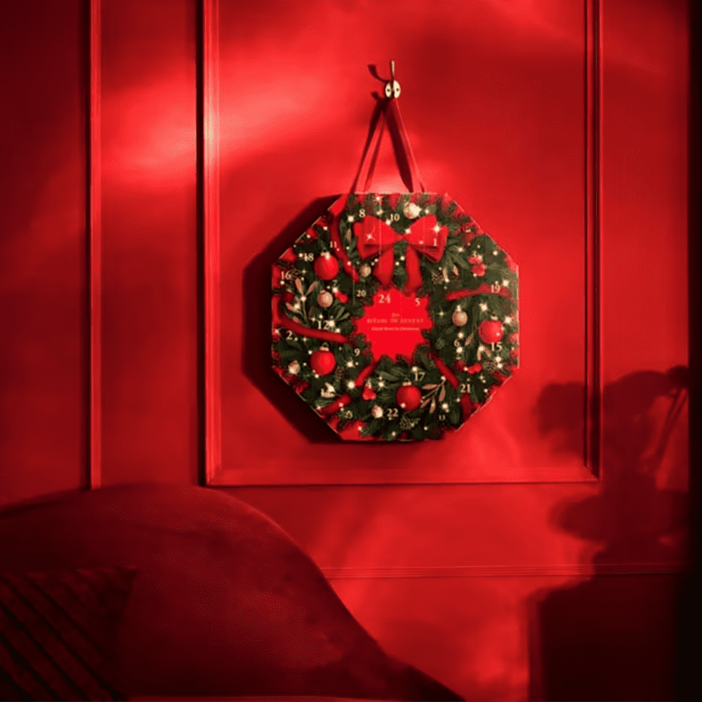 Rituals wreath advent calendar 2025 hanging on a red wall