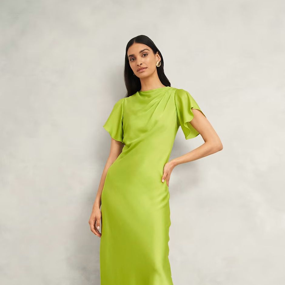 casual wedding guest dress in lime green, featuring bias cut and flutter sleeves