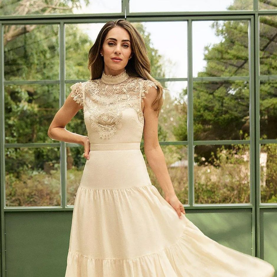 vintage style wedding dress in ivory with detailed lace bodice that leads to a flowing maxi length skirt.