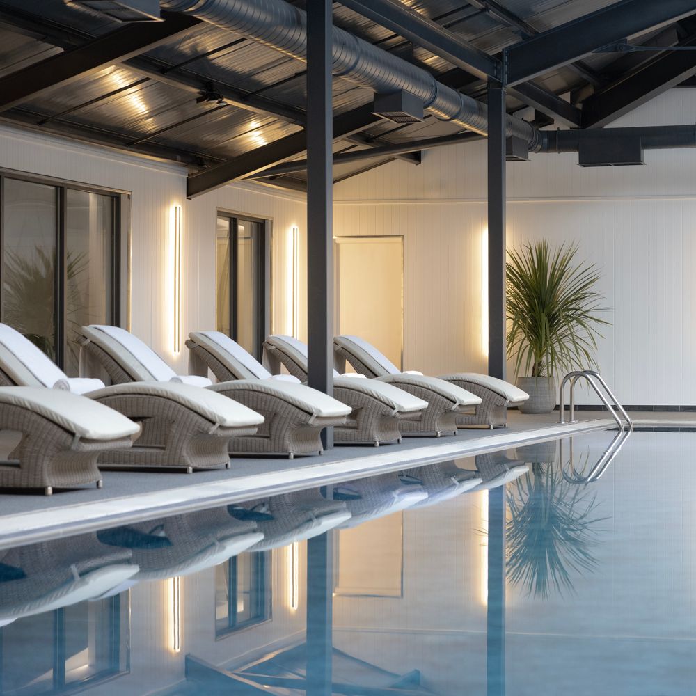 Swimming pool with luxury loungers at JA Mar Hall