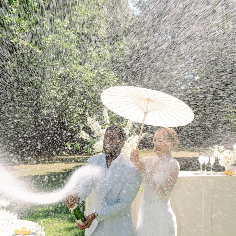 Light blue and white wedding theme champagne spray moment