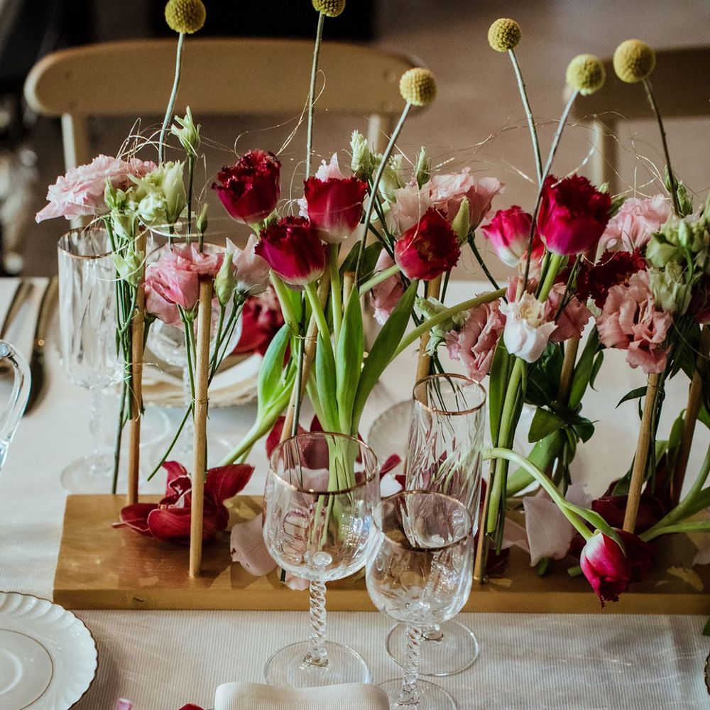 Pink and green wedding flowers on table