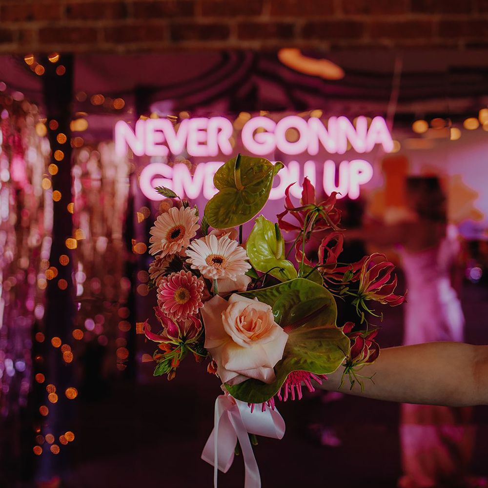 Pink and green wedding flowers with neon sign