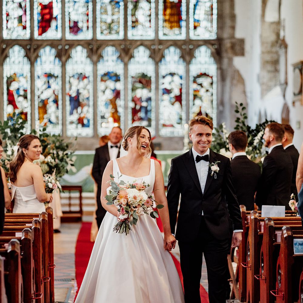 bride-and-groom-walking-down-the-aisle-at-church