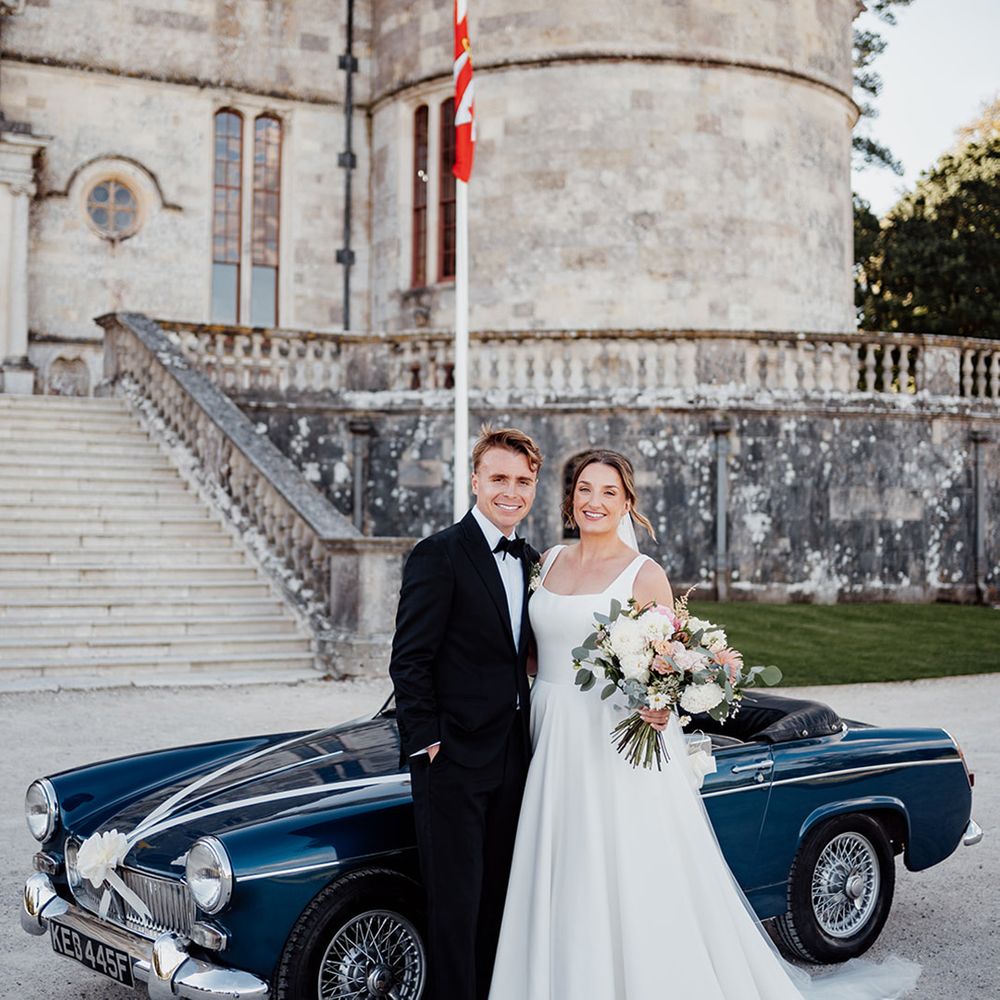 bride-and-groom-with-their-vintage-blue-wedding-car