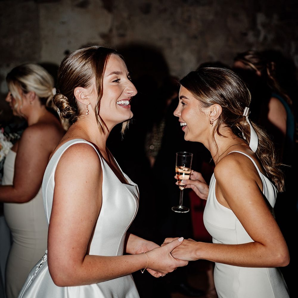 bride-dancing-with-bridesmaid-at-wedding-reception