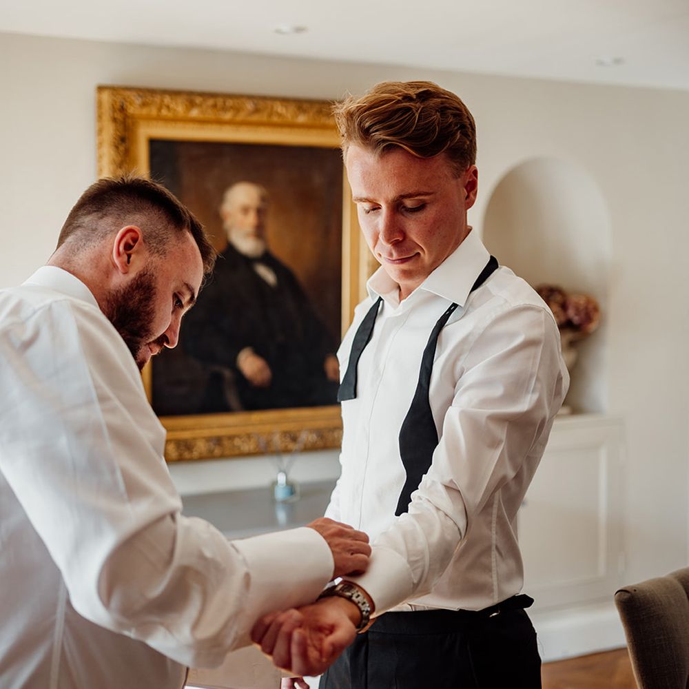 groom-gets-cufflinks-added-as-he-gets-ready-for-wedding