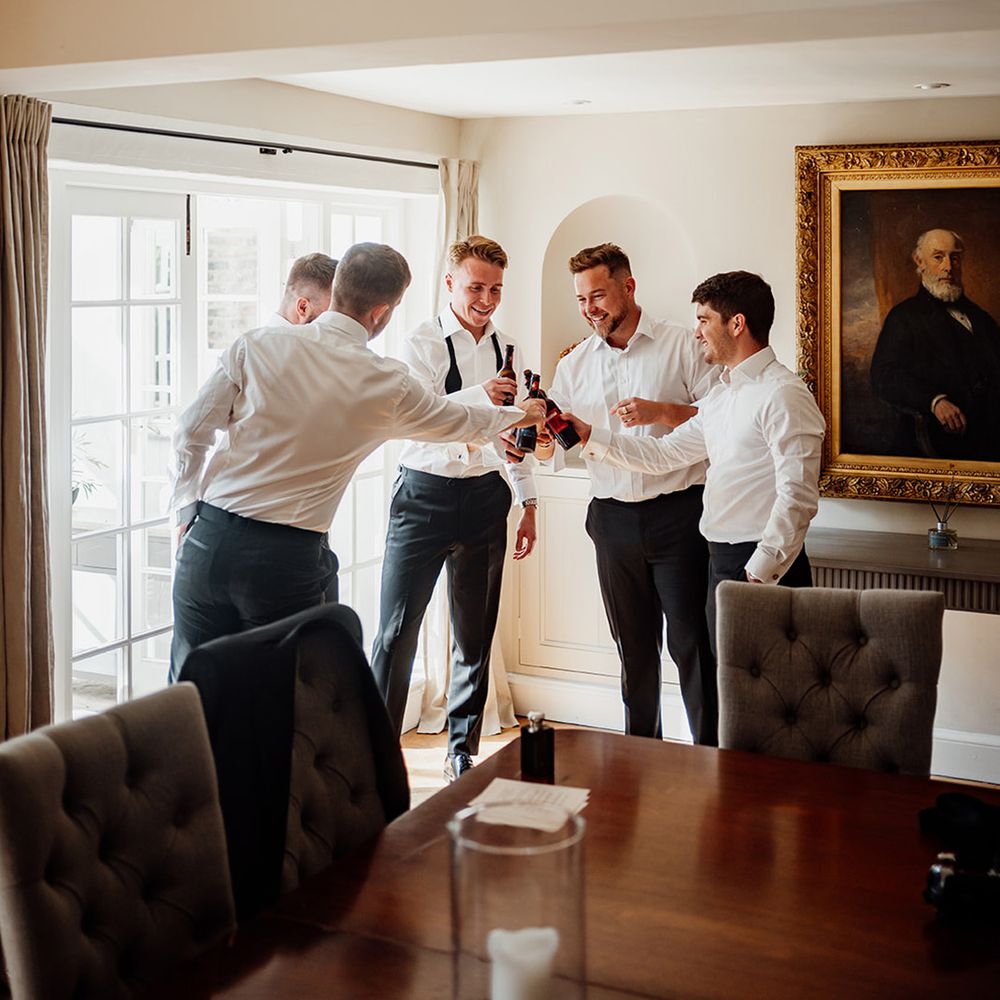 groomsmen-cheersing-with-groom-on-morning-of-the-wedding