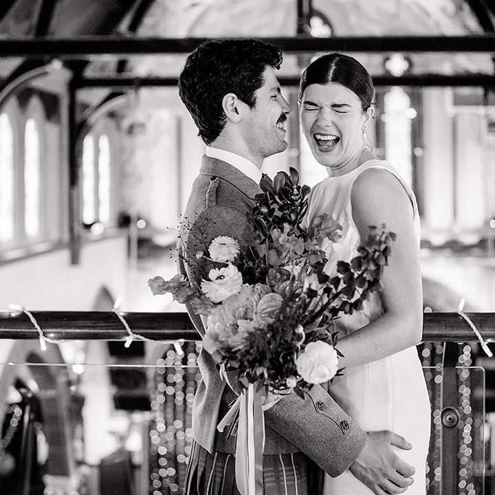 bride-smiles-as-he-poses-with-the-groom