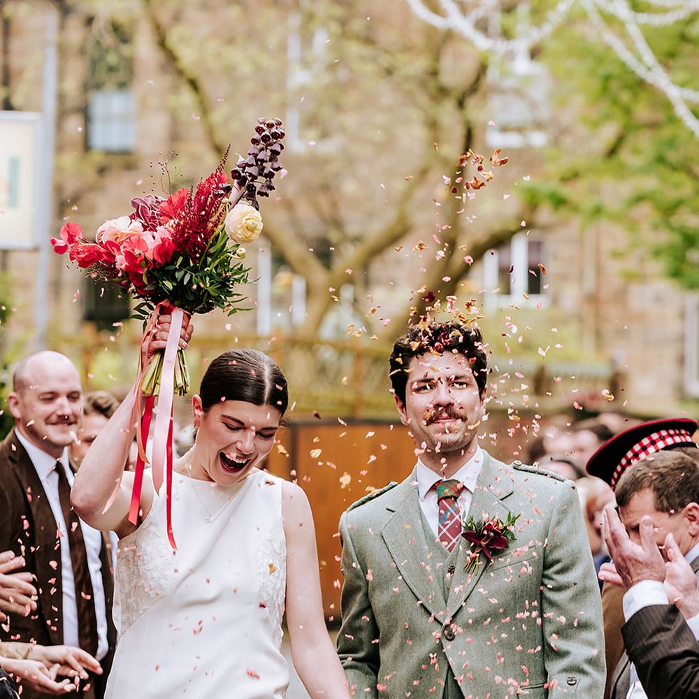 guests-throw-dried-flower-petal-confetti-over-the-couple
