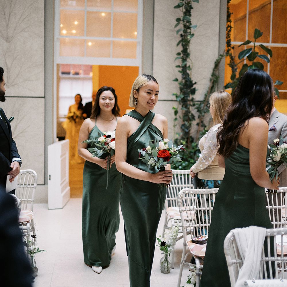 bridal-party-wearing-dark-green-bridesmaid-dresses