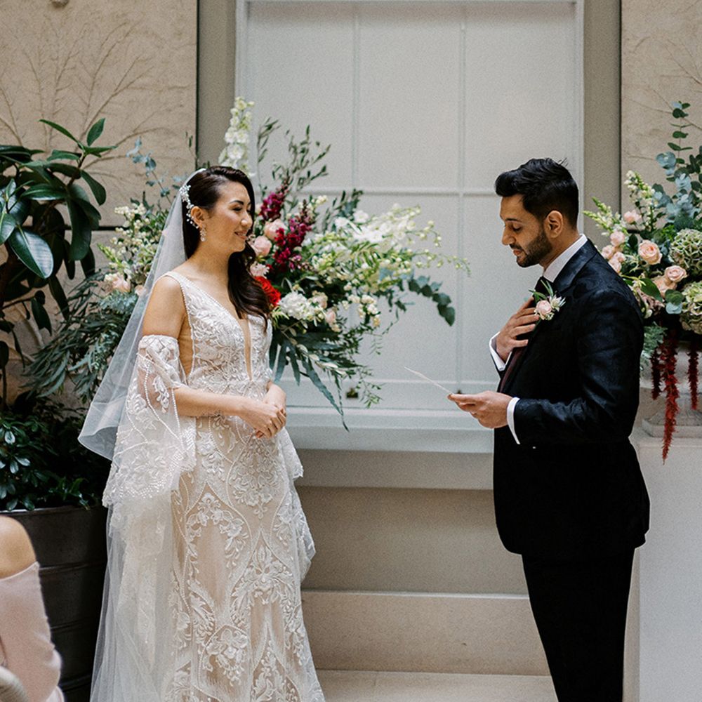 groom-reads-wedding-vows-with-bride-in-lace-wedding-dress