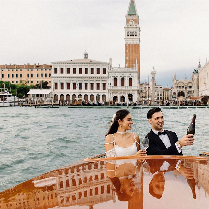 groom-pops-bottle-of-champgne-on-boat