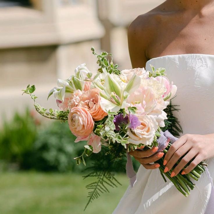 Bride with Coral Pink Wedding Nails Holding Colourful Bouquet