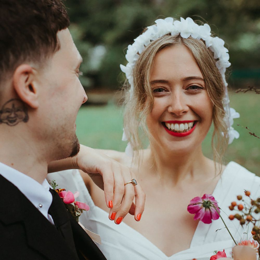 Bride wearing bright red wedding nails