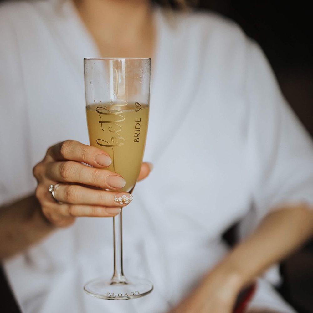 Bride with white floral nail art on accent nail