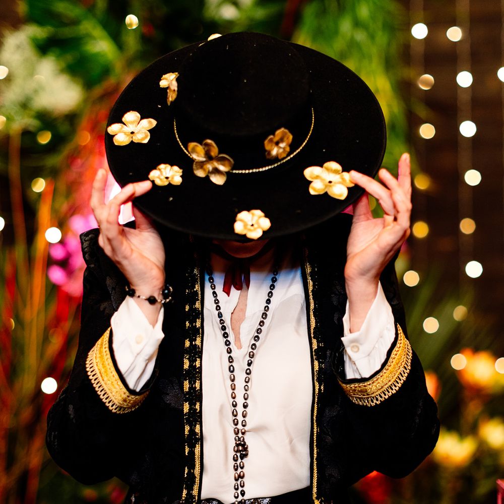 bride-wearing-black-brimmed-hat-with-gold-flowers