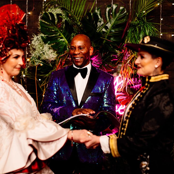 celebrant-in-sequin-jacket-and-brides-at-ceremony