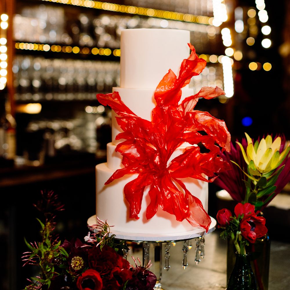 three-tier-white-wedding-cake-with-red-floral-detail.