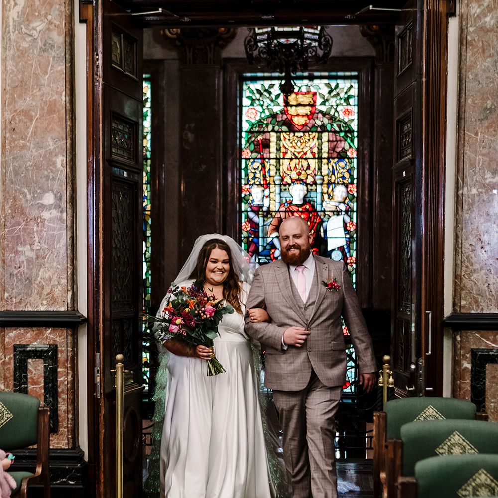 bride-walks-down-the-aisle-at-church-wedding