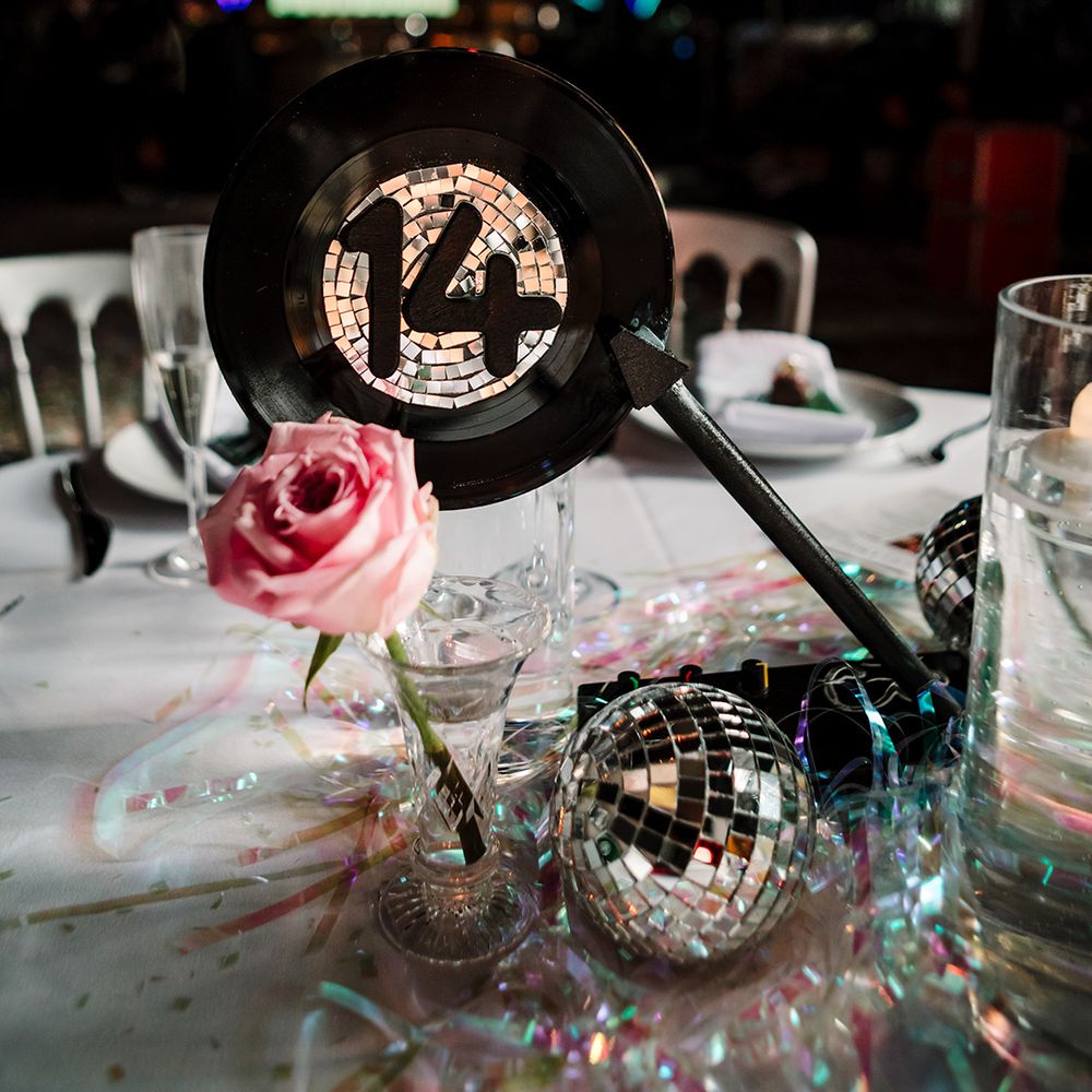 diy-wedding-table-number-signs-made-from-vinyl-and-disco-balls