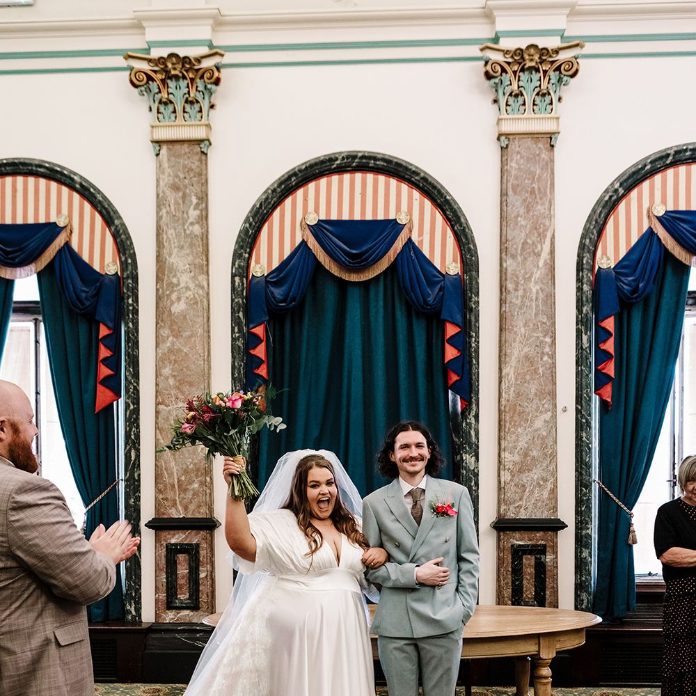 groom-in-light-blue-wedding-suit-with-bride-at-wedding-ceremony