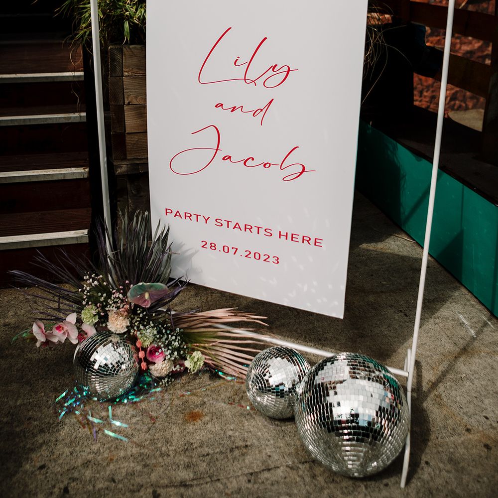 red-and-white-wedding-welcome-sign-with-disco-balls