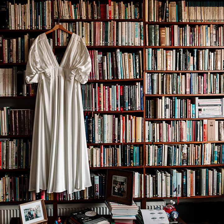 satin-asos-wedding-dress-hanging-on-bookshelves