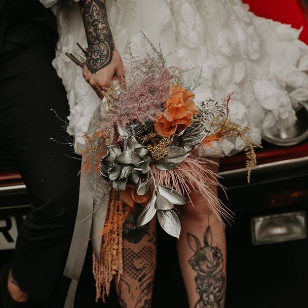 groom-holding-metallic-bouquet