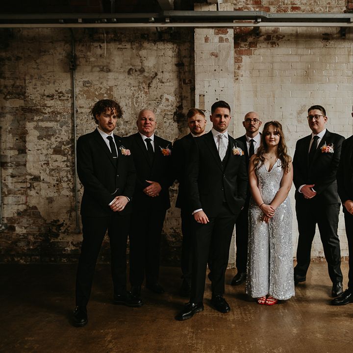 groomsmen-in-matching-suits-and-groomswoman-in-sparkly-jumpsuit