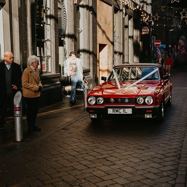 vintage-red-wedding-car-with-white-ribbon