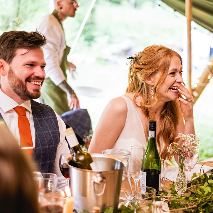 bride-and-groom-laughing-at-wedding-breakfast