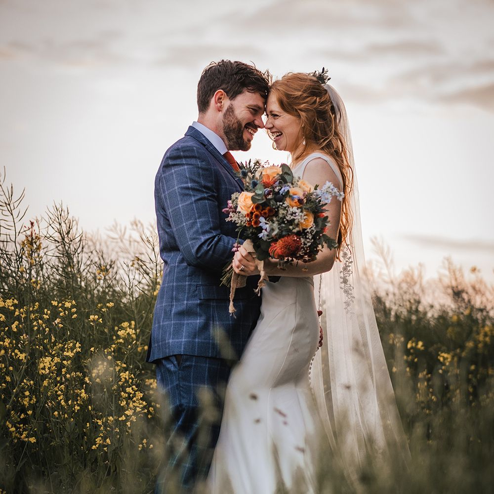 bride-and-groom-rest-foreheads-against-each-other-for-couple-portrait