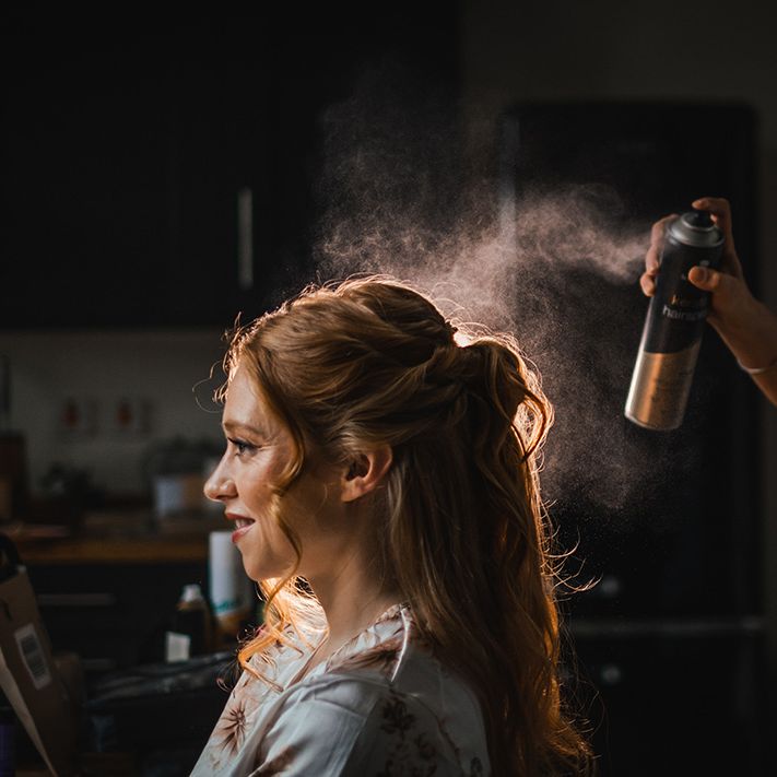 bride-gets-hair-done-for-wedding-day-with-hairspray