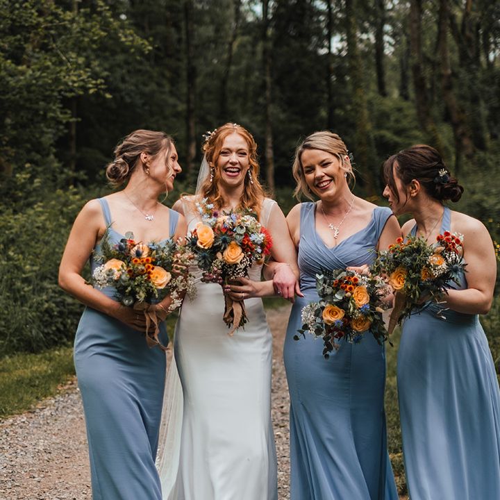 bridesmaids-wearing-blue-bridesmaid-dresses-with-bride