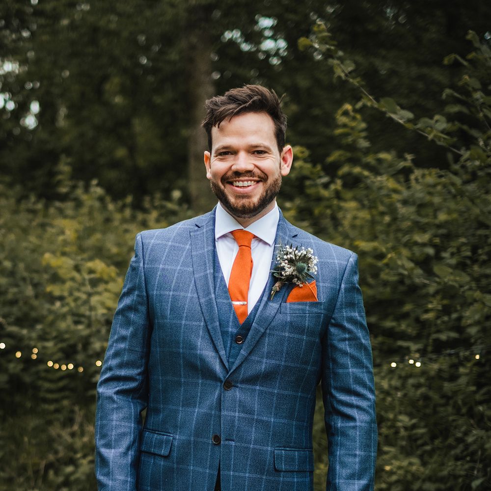 groom-in-checkered-dark-blue-suit-with-orange-ties