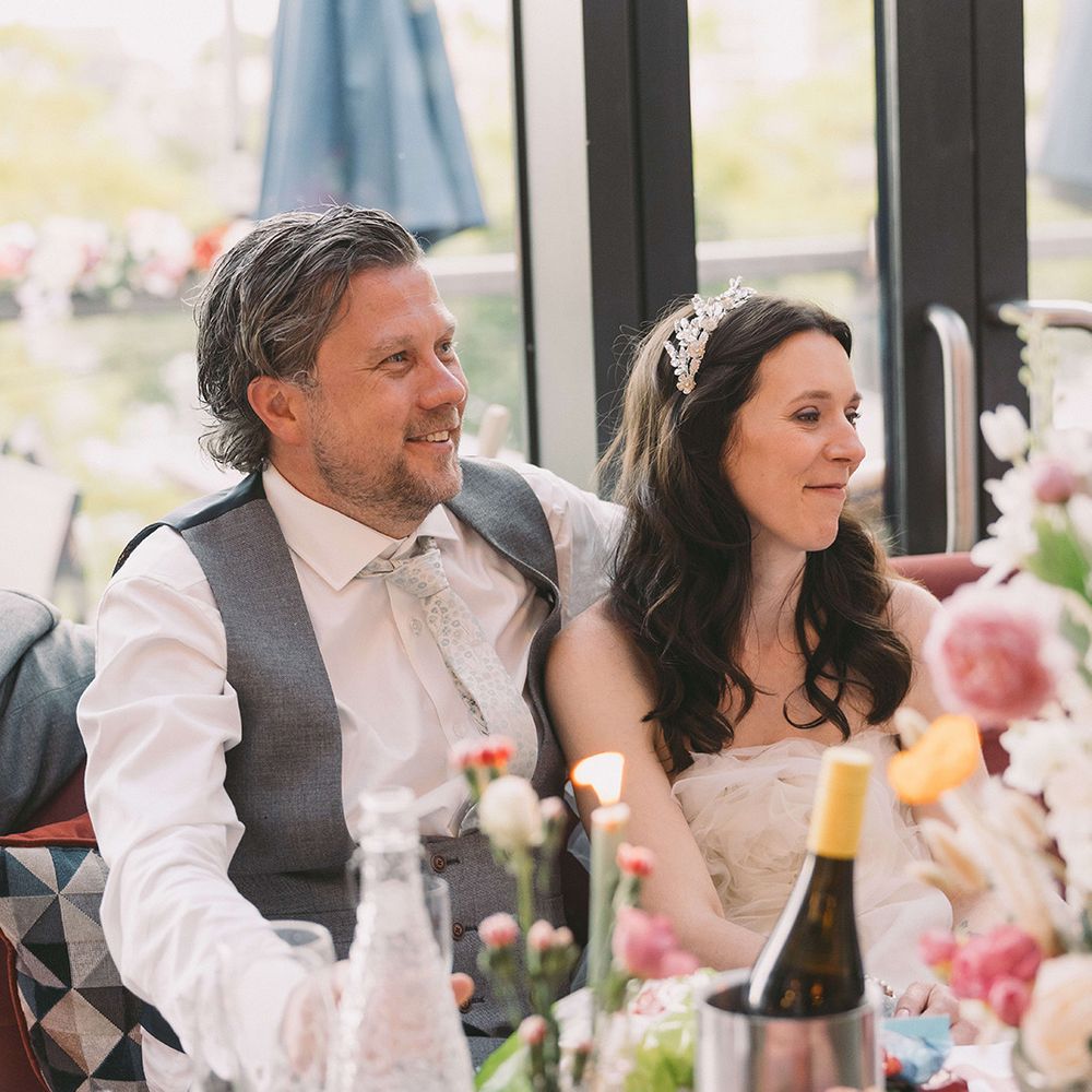 bride-and-groom-listening-to-wedding-speeches