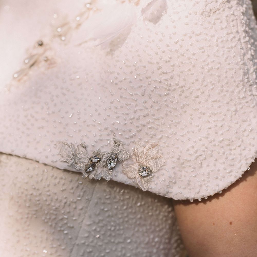 bride-wearing-bespoke-pearl-wedding-dress-and-bolero
