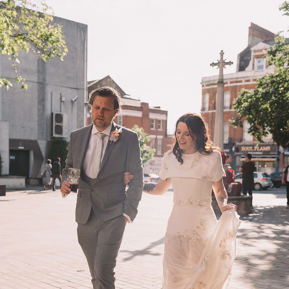 groom-in-grey-suit-with-bride-walking-around-city